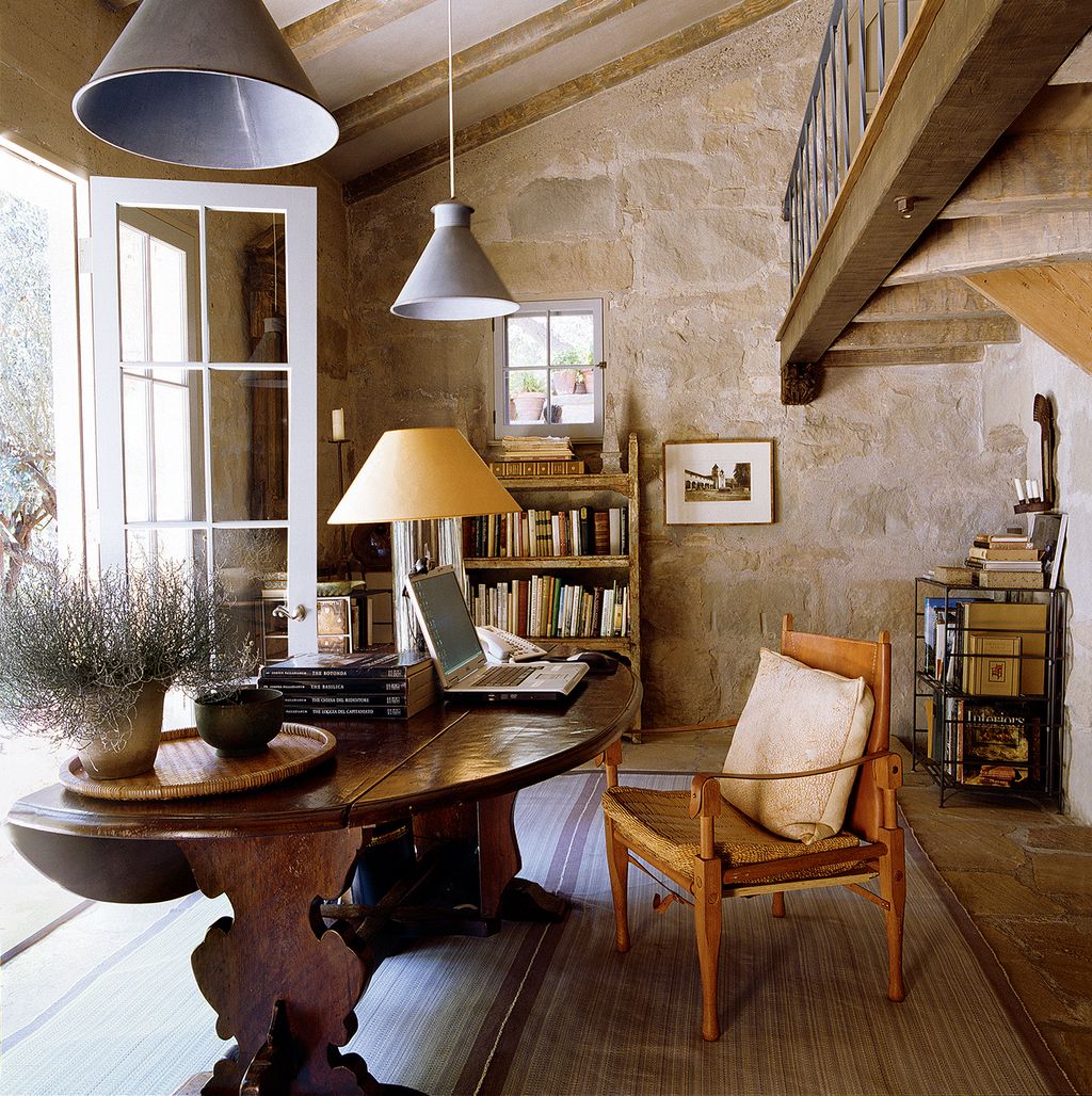 A balcony overlooks John's study the lamp on the table is one of his earliest designs created in 1970 and still in...