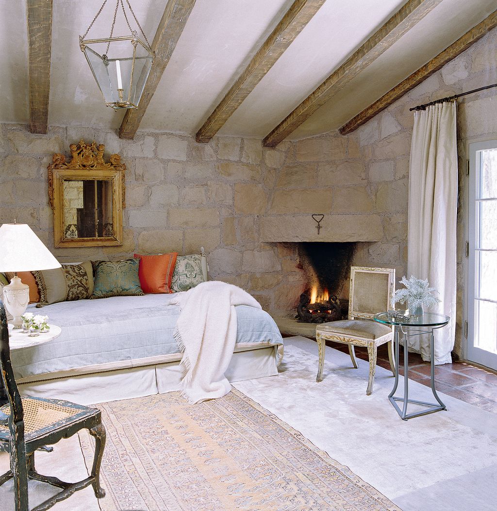 The glass tripod table in Betty's bedroom is another of John's designs the curtain over the french window also conceals...