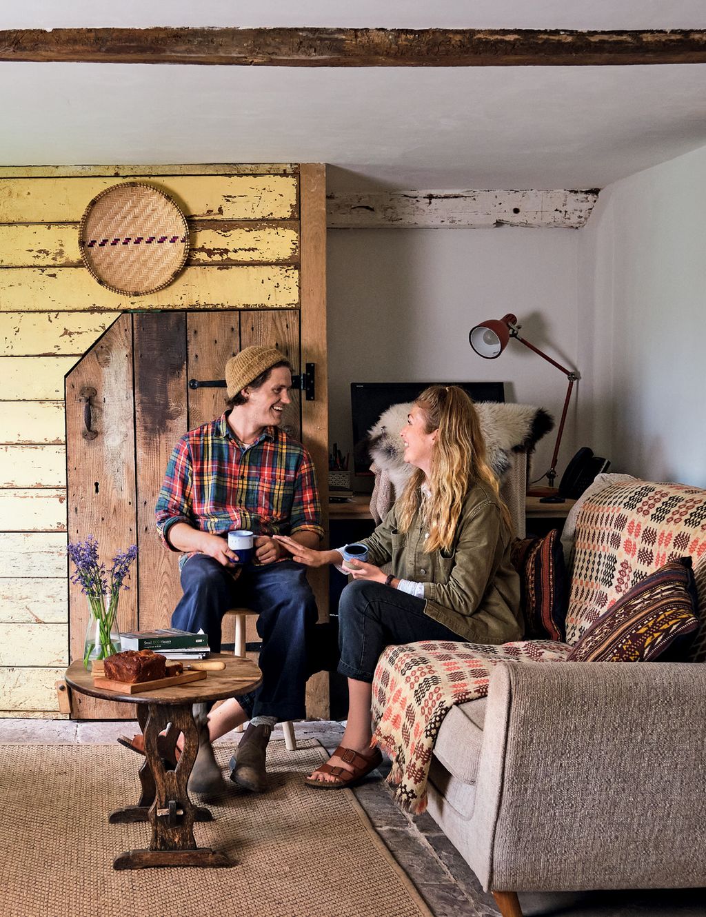 Image may contain Sitting Human Person Furniture Couch Living Room Room Indoors Clothing Apparel and Wood