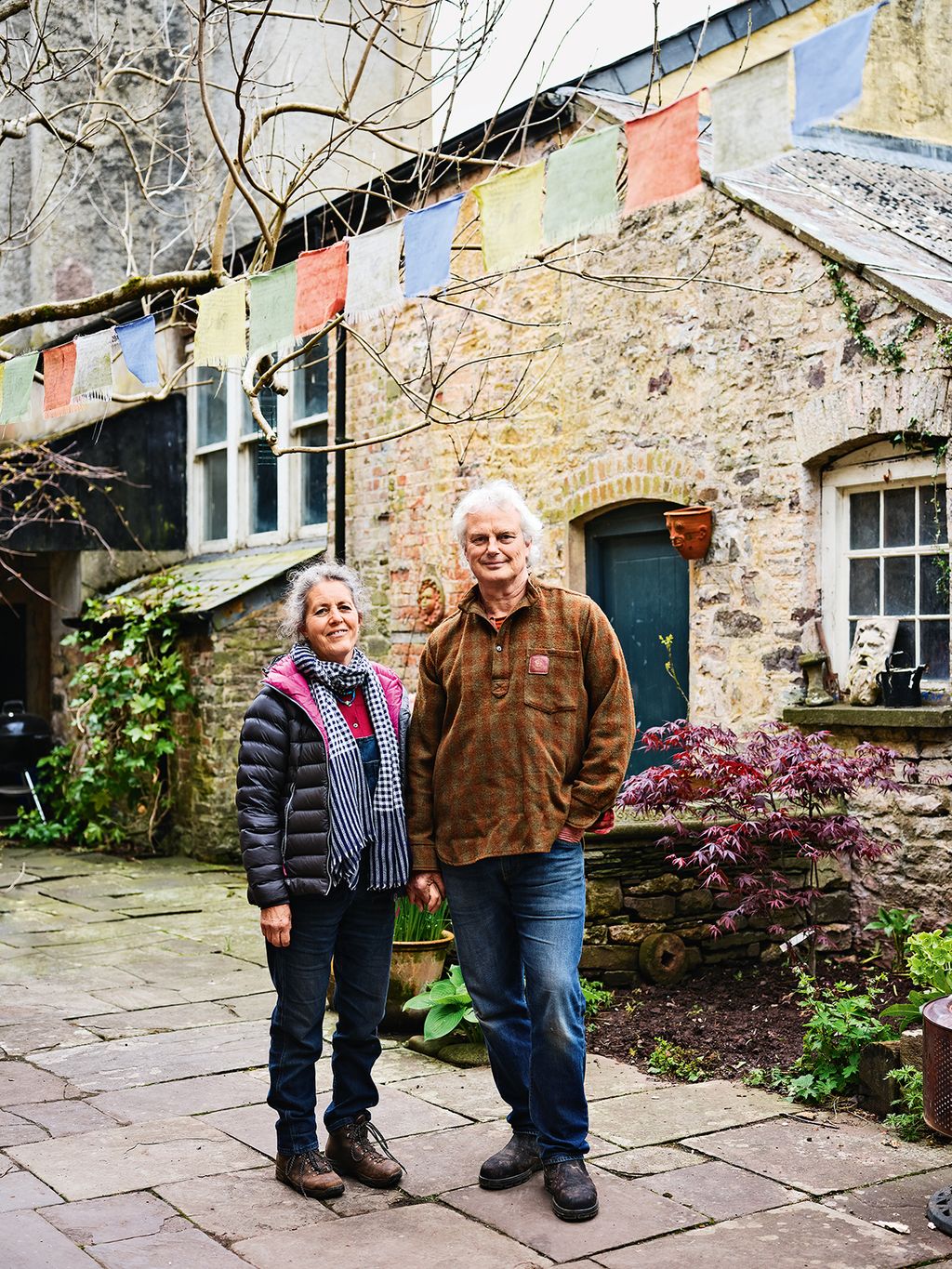 Vina and Gavin in the courtyard behind the house where they have converted a service wing into guest accommodation.