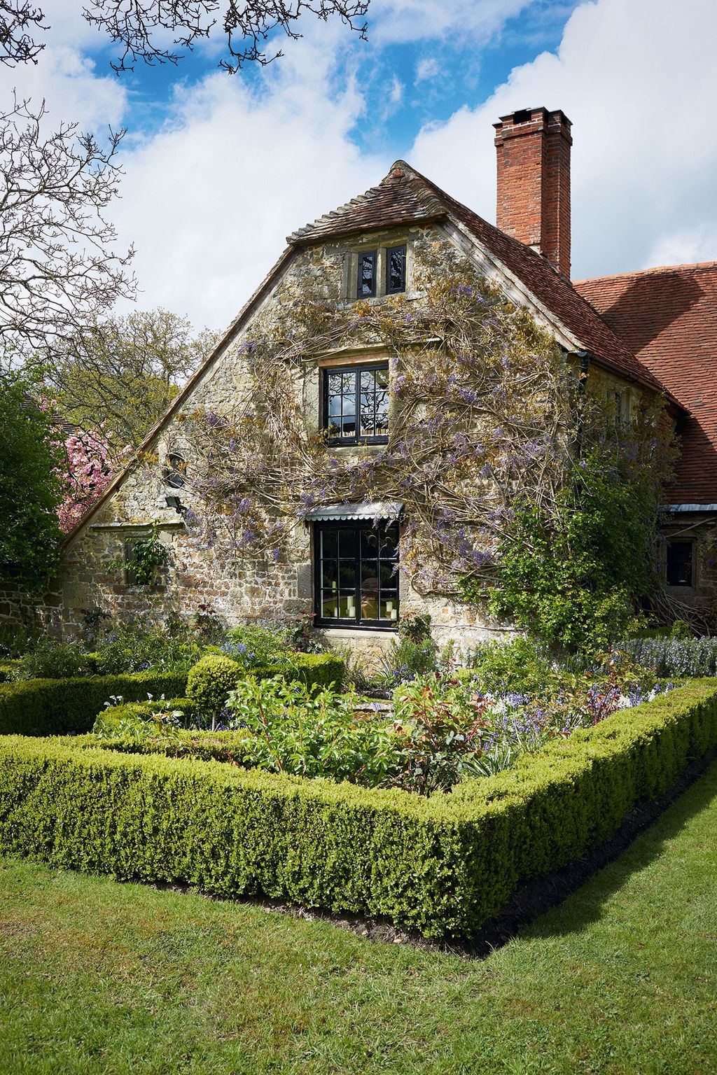 Image may contain House Cottage Housing Building Outdoors Plant Grass Garden Roof and Nature