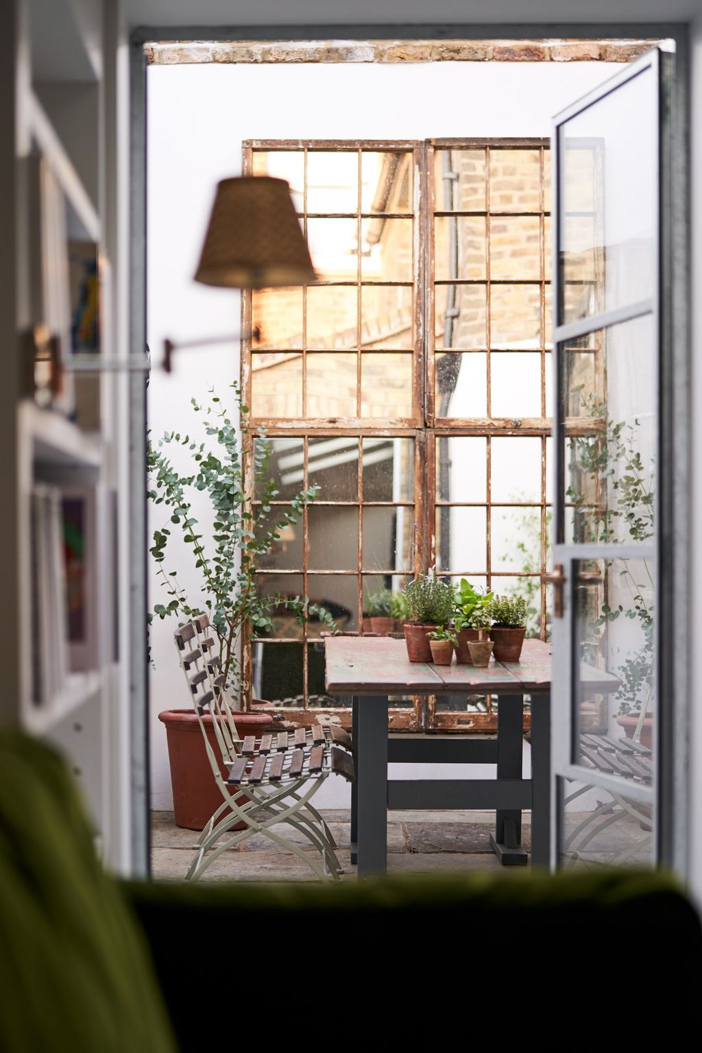 A house on Columbia Road  The courtyard was reinstated it had been a bedroom we hung old sash windows with mirrorplate...
