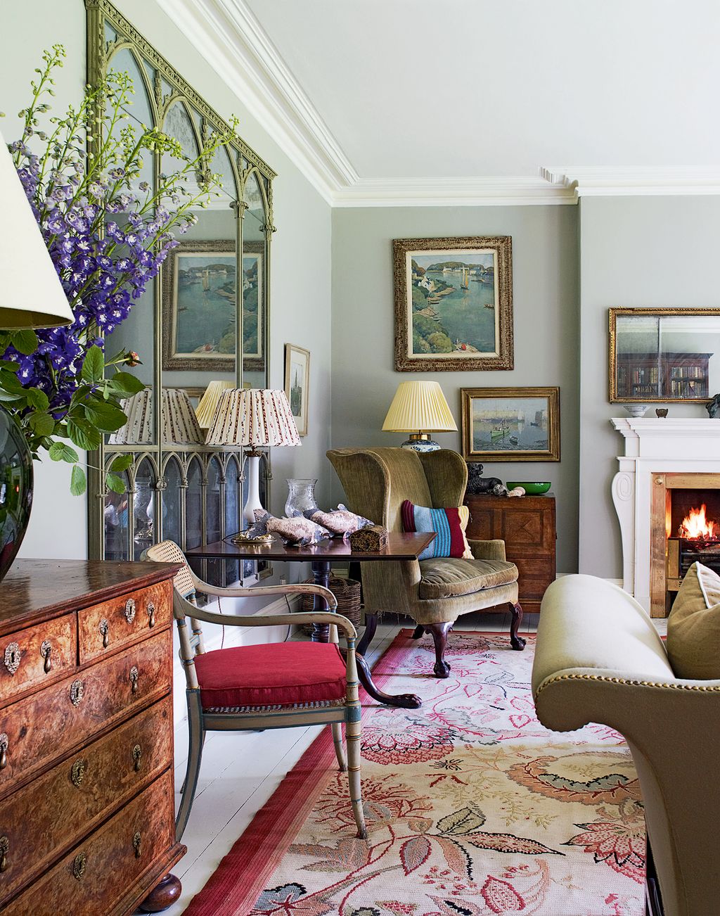 Image may contain Living Room Room Indoors Interior Design Furniture Rug Lamp Table Lamp and Home Decor