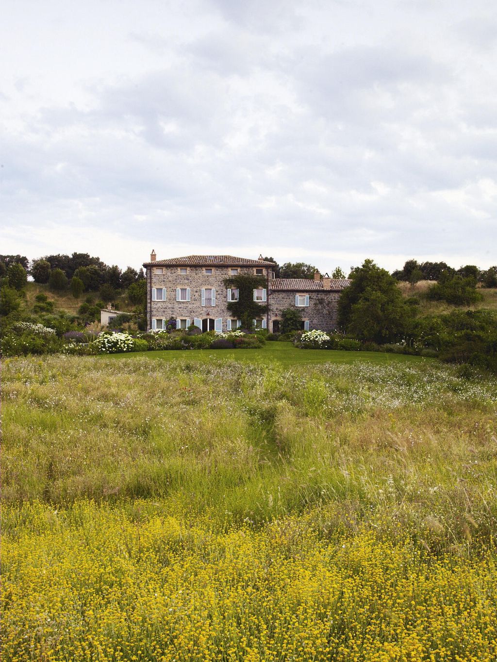 Image may contain Grassland Outdoors Field Nature Countryside Grass Plant Rural Farm Meadow Housing and Building