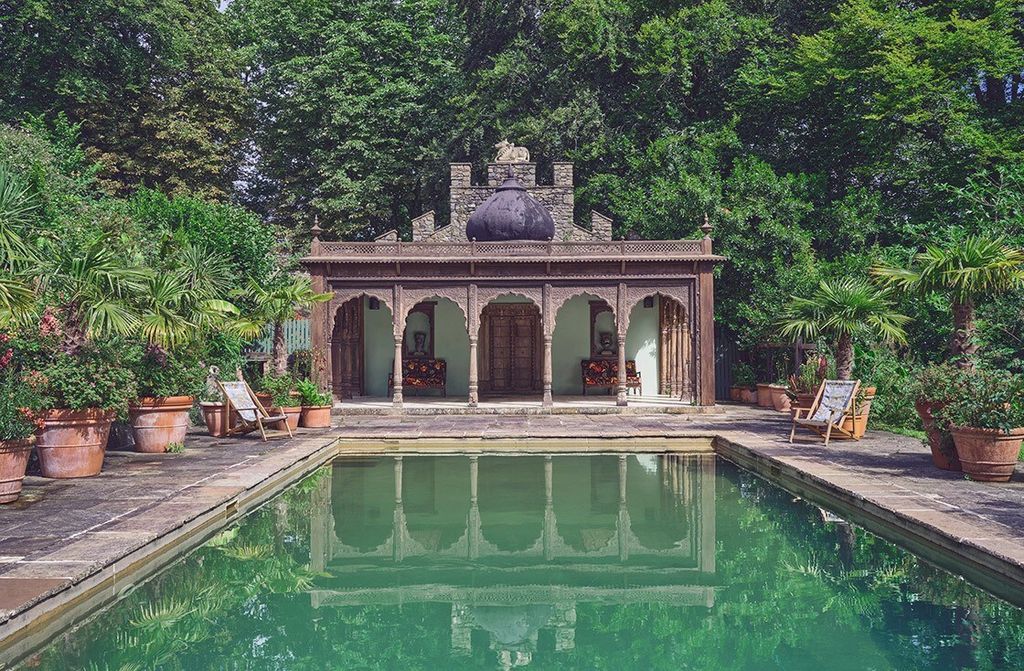 Image may contain Building Resort Hotel Pool Water Garden and Outdoors