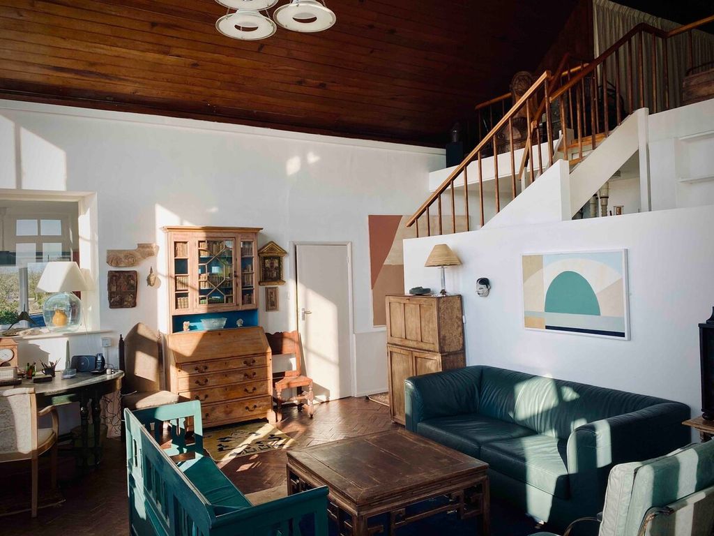 Image may contain Housing Building Wood Living Room Room Indoors Loft Furniture Couch Interior Design and Flooring