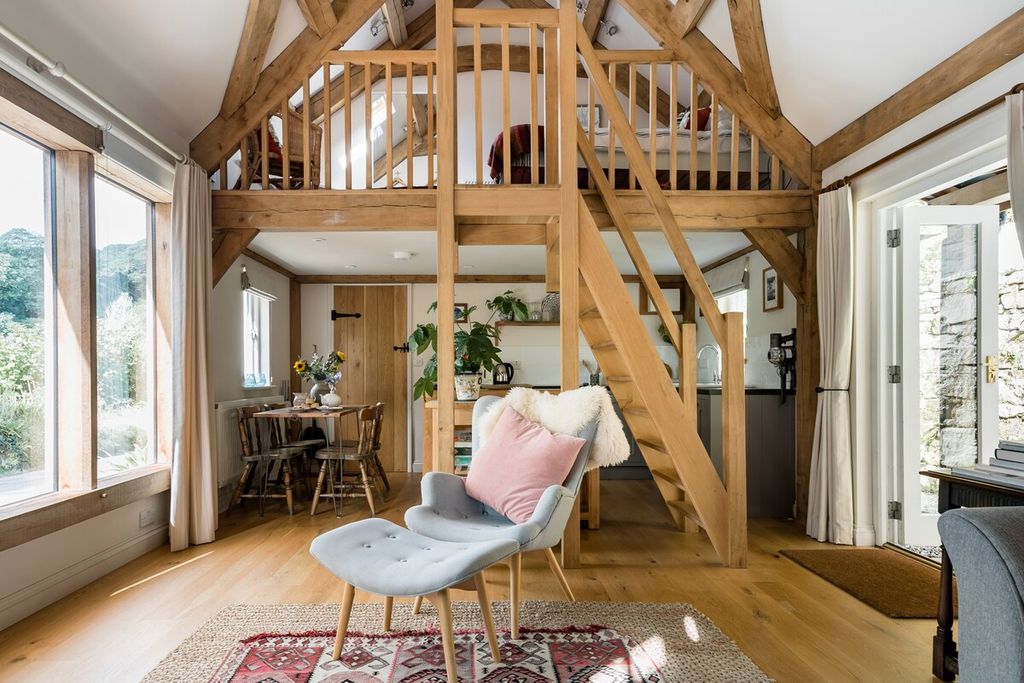 Image may contain Loft Housing Building Wood Indoors Furniture Chair Hardwood Living Room Room Flooring and Attic