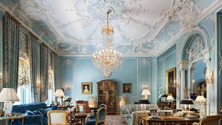 Image may contain Furniture Room Indoors Reception Waiting Room Reception Room Living Room Couch Chair and Lamp