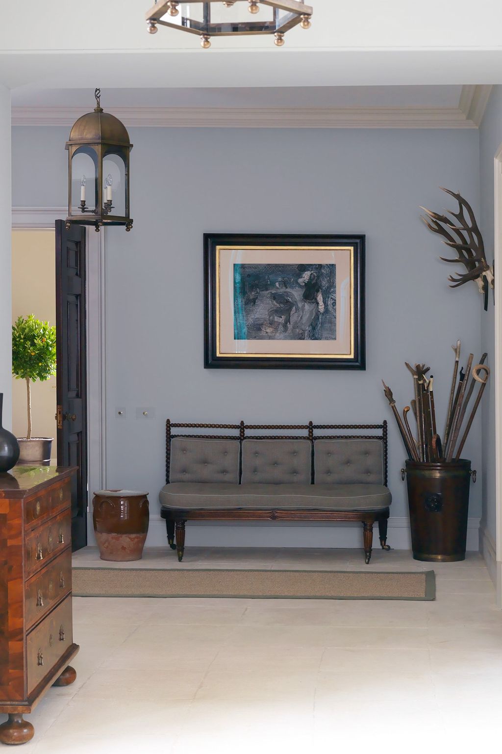 Image may contain Furniture Living Room Room Indoors Couch Appliance Ceiling Fan Interior Design Plant and Cabinet