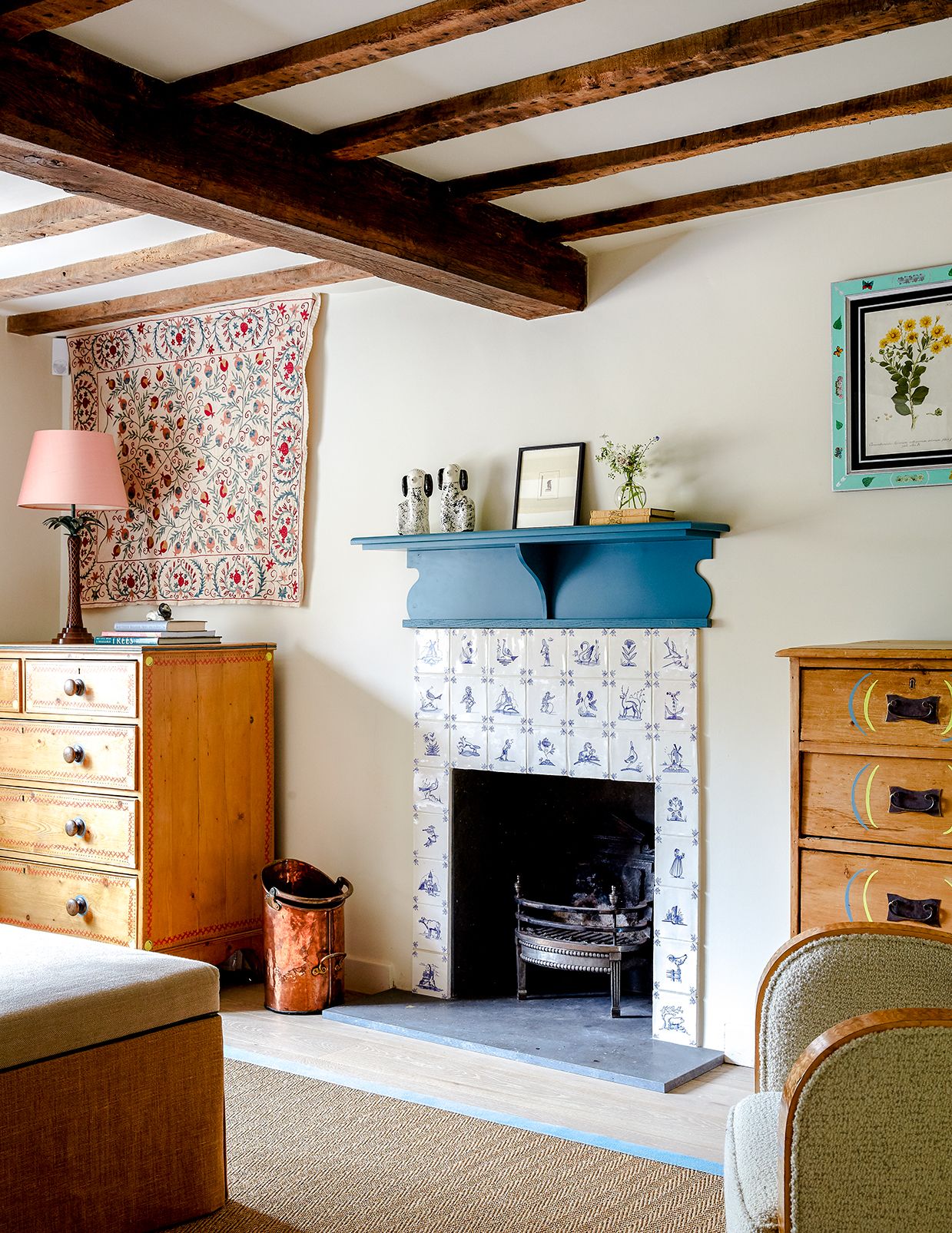 In the snug of a Sussex cottage designed by Beata Heuman handpainted Delft tiles from Norton Tile Company are used to...