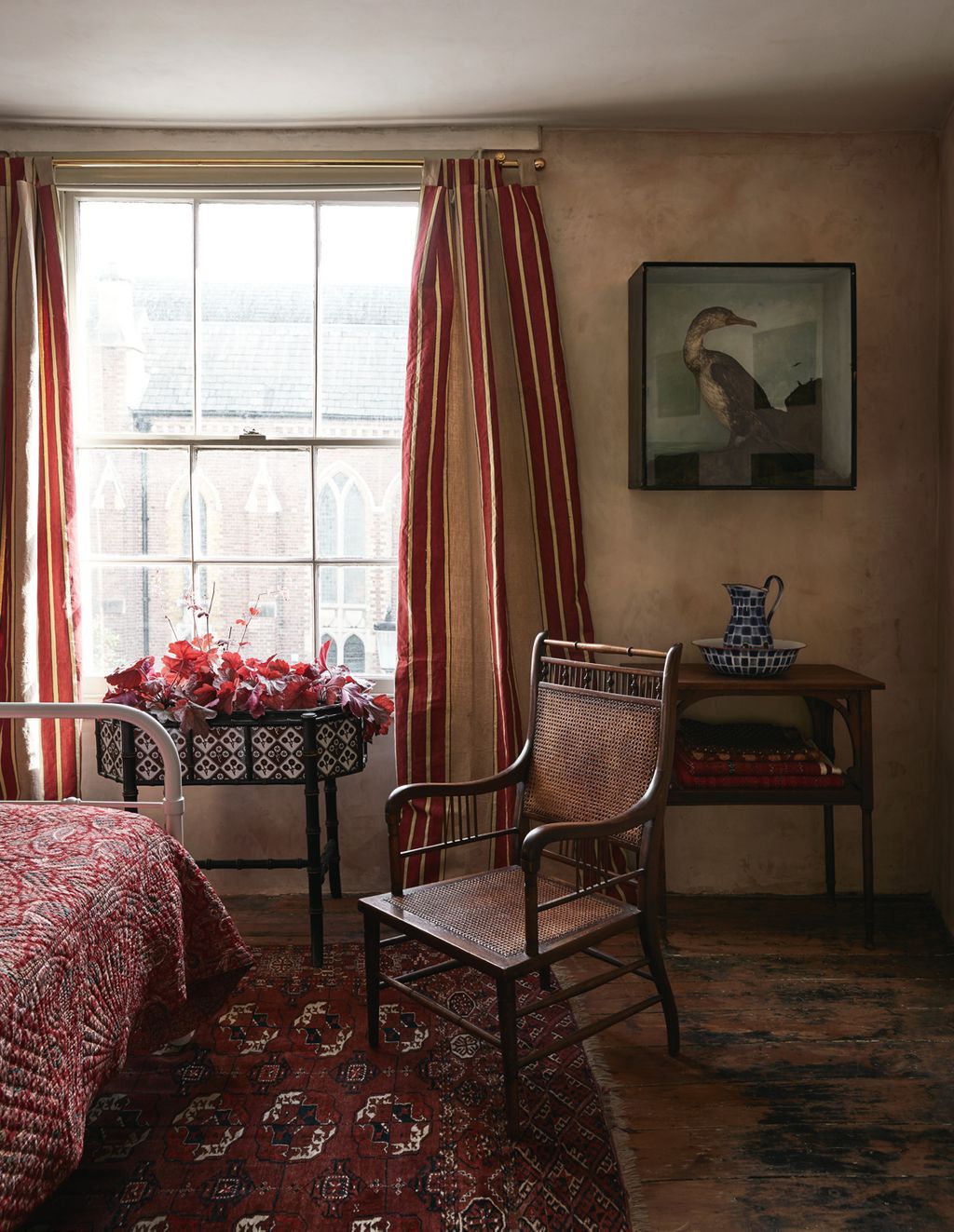 Image may contain Interior Design Indoors Furniture Living Room Room Chair Home Decor Plant Flooring and Flower