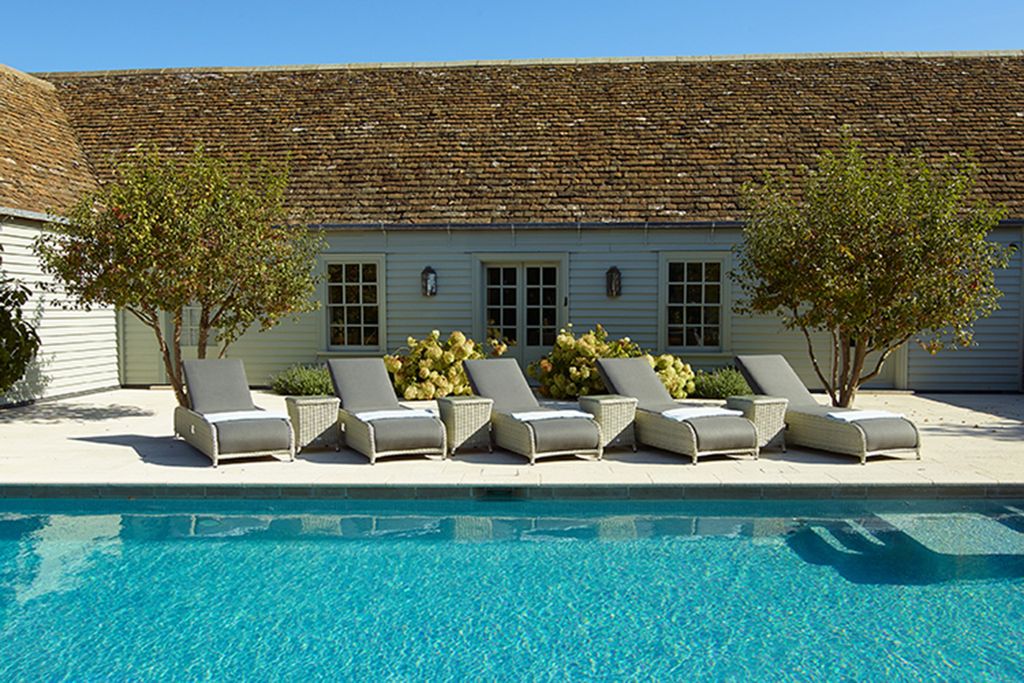Image may contain Housing Villa House Building Cottage Pool Water Furniture Chair and Swimming Pool