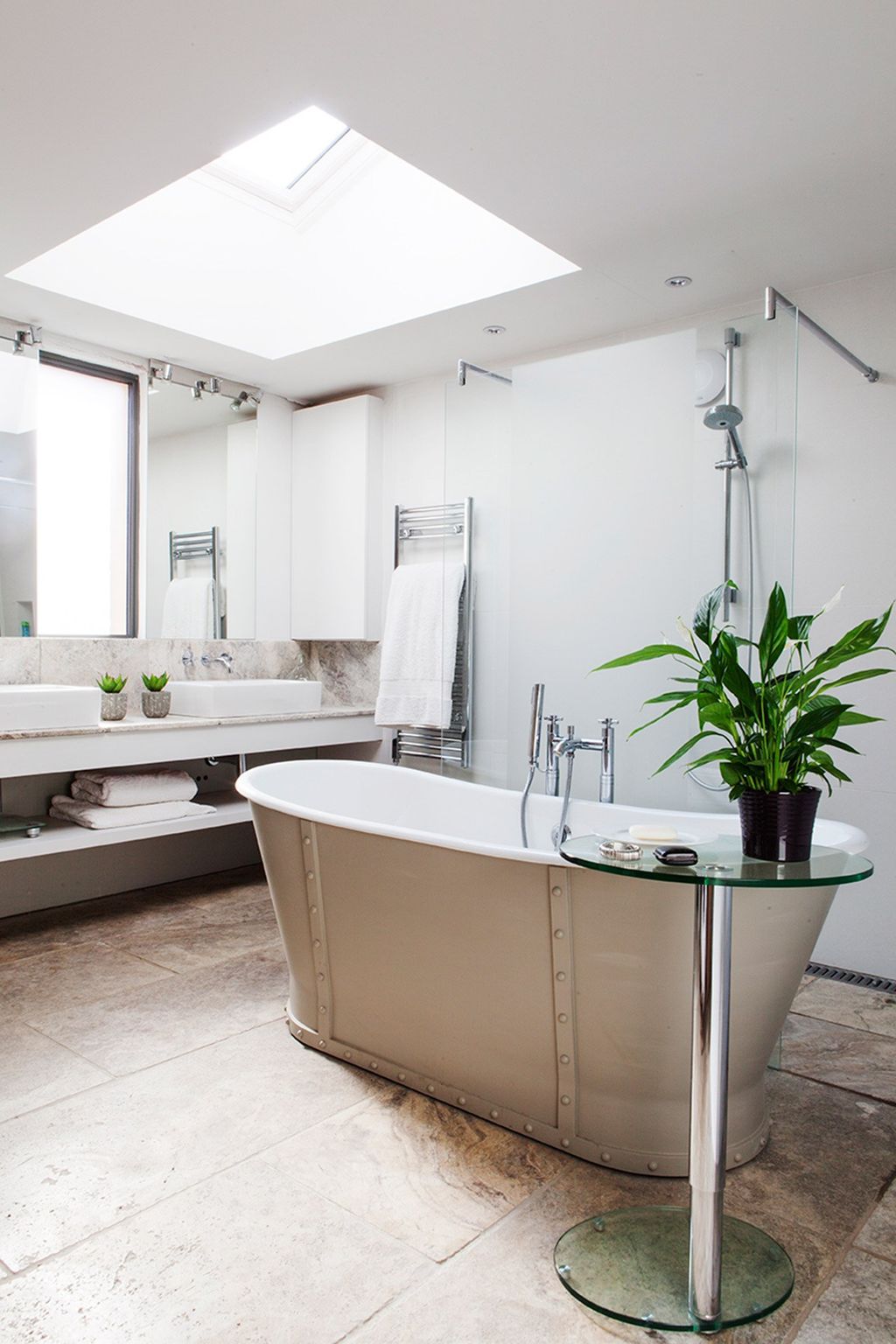 A castiron tub from Aston Matthews painted in Farrow  Ball's 'Hardwick White' is the focal point of the main bathroom. ...