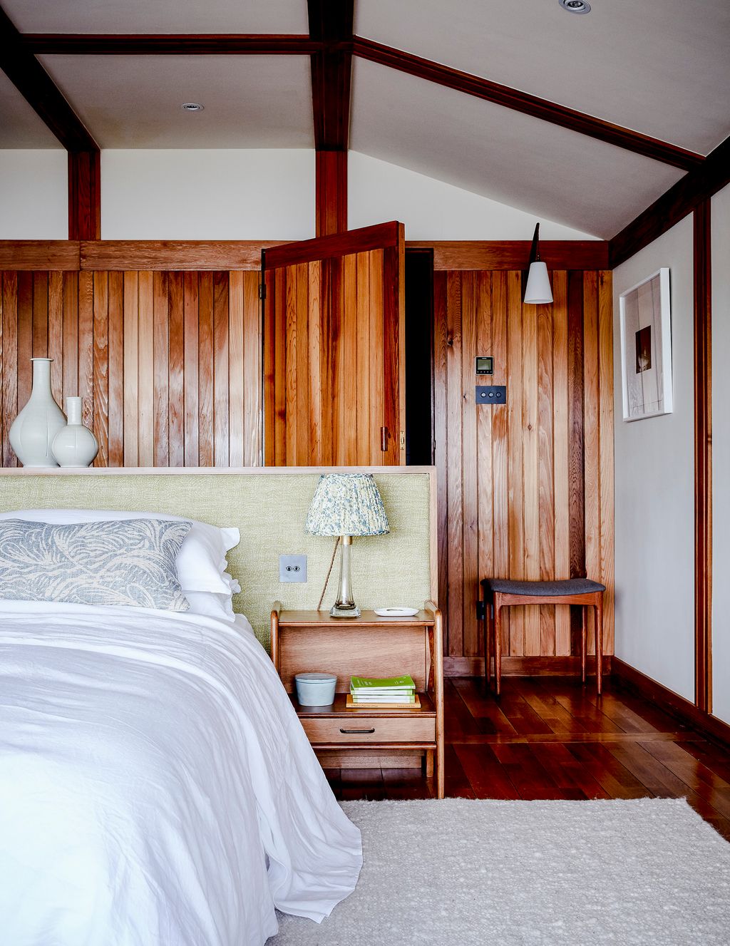 Image may contain Wood Indoors Room Bedroom Hardwood Furniture Bed Flooring Interior Design and Floor