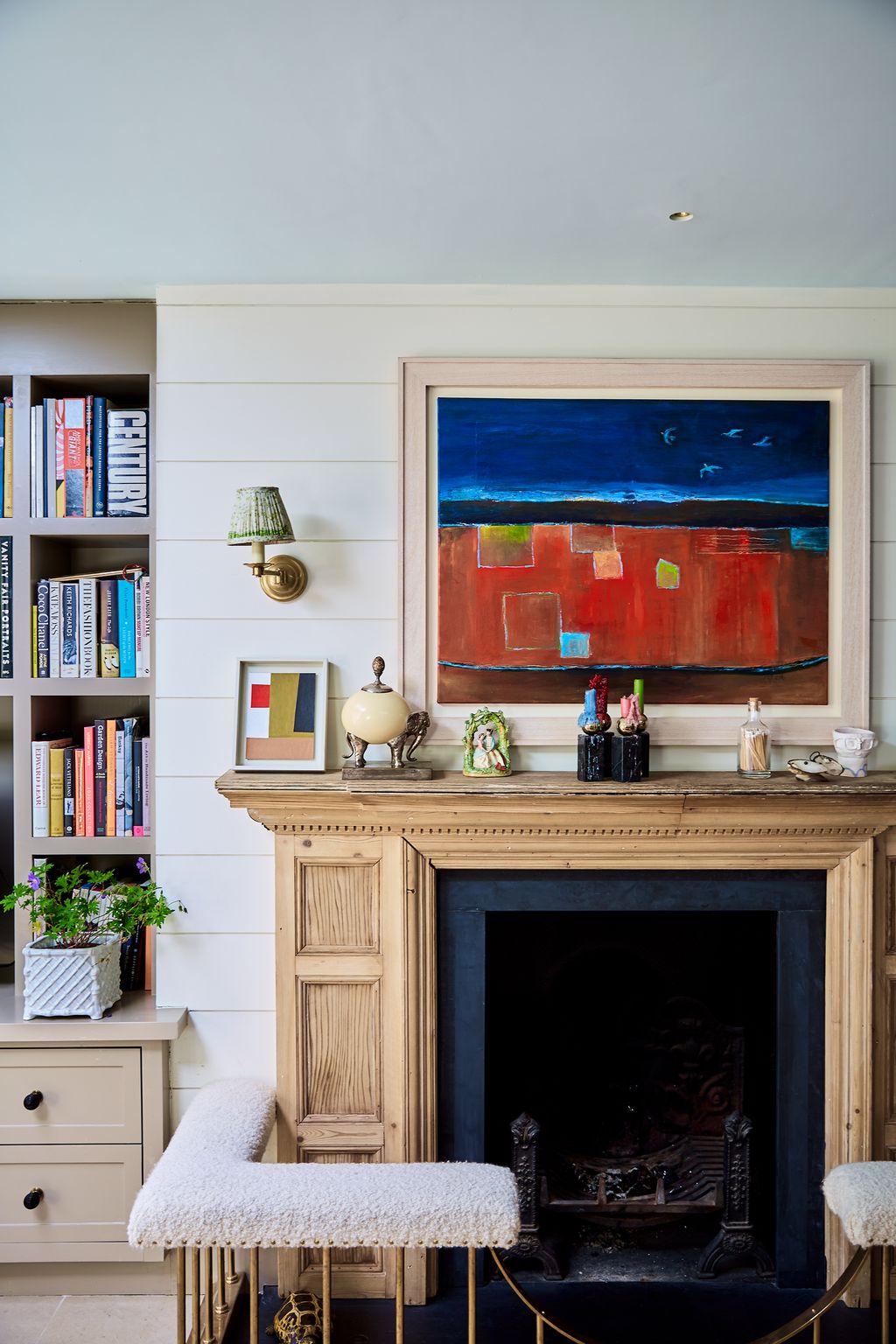 Image may contain Furniture Fireplace Indoors Bookcase Interior Design Hearth Living Room and Room