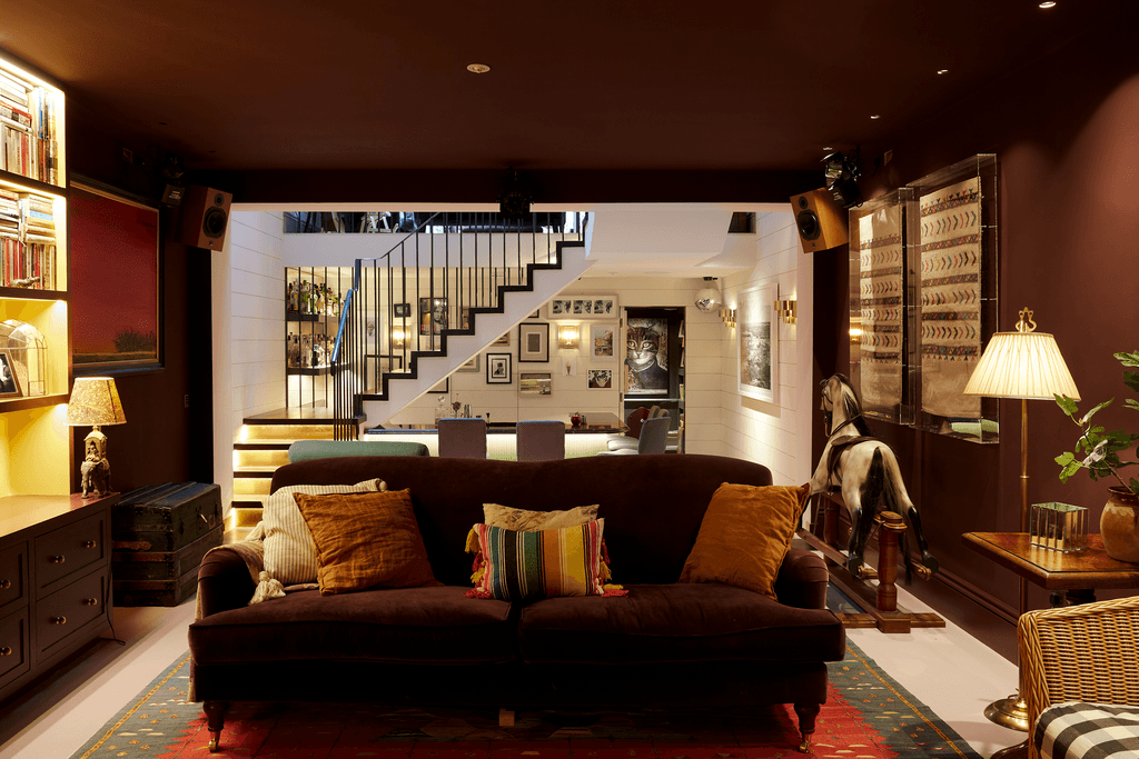 The walls in the basement are painted in Farrow  Ball's 'Pelt'. The pale pink concrete floor is mostly covered with a...