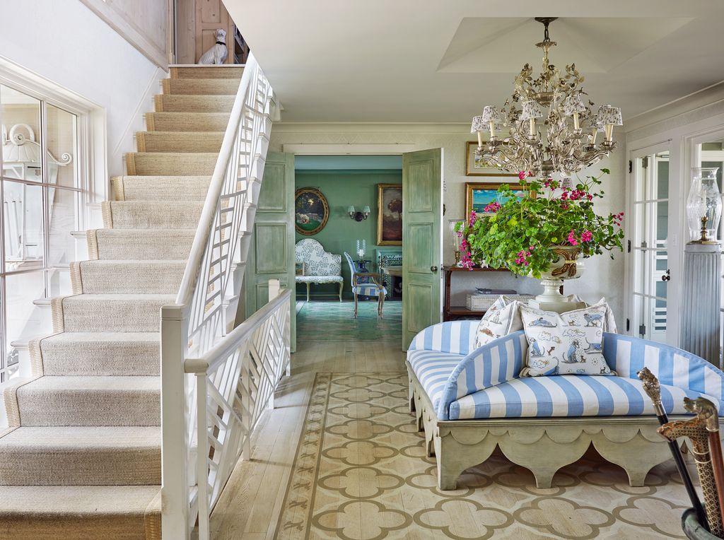 Image may contain Staircase Living Room Room Indoors Flooring Furniture Couch Interior Design Wood and Hardwood