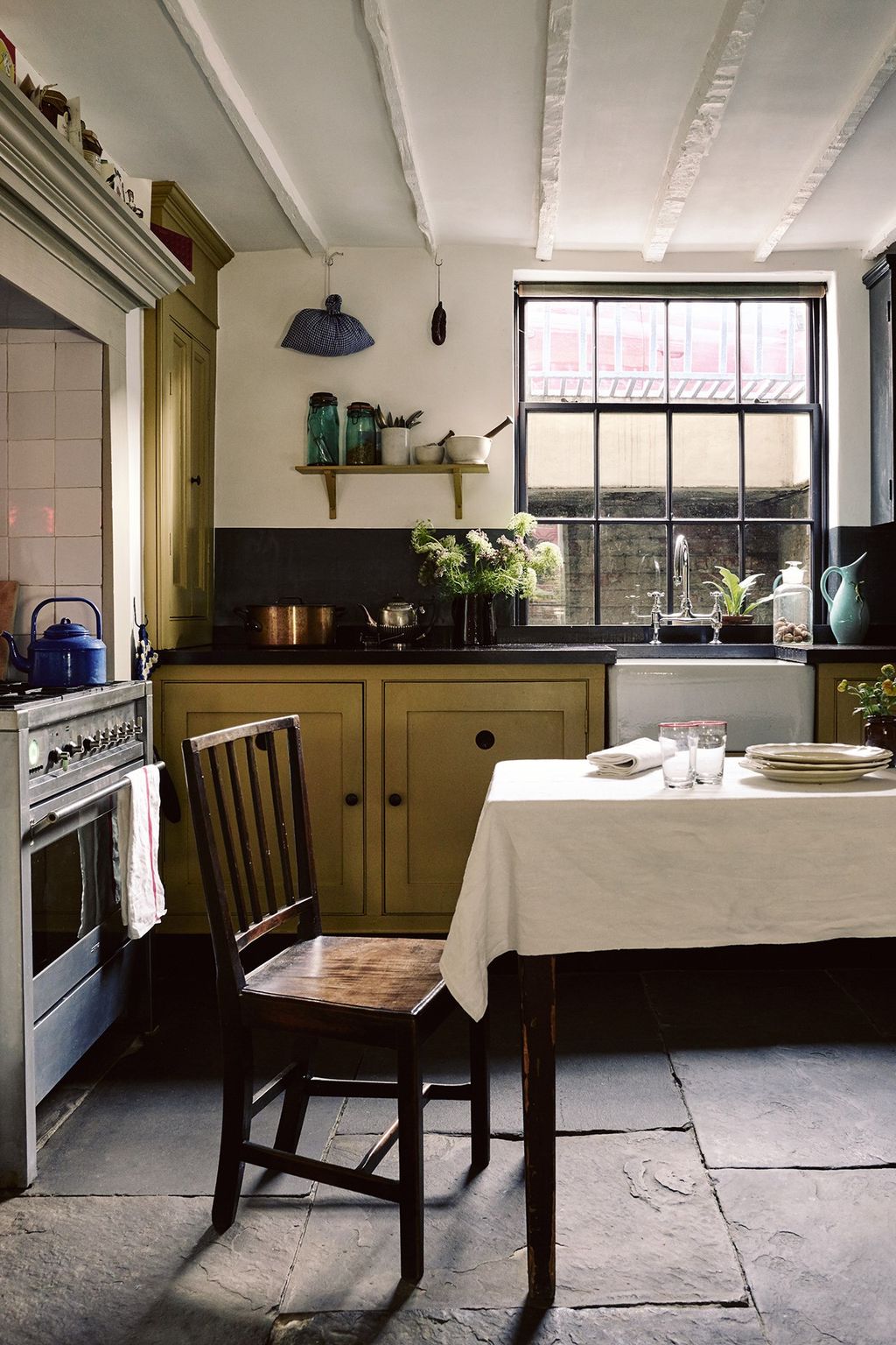 Image may contain Furniture Chair Room Indoors Home Decor Interior Design Kitchen Kitchen Island Wood and Plant