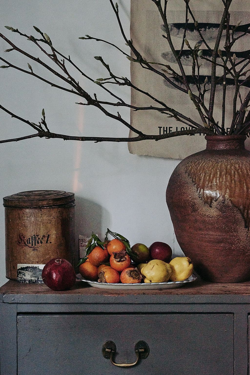 A seventeenthcentury Japanese stoneware tsubo jar serves as a vase.