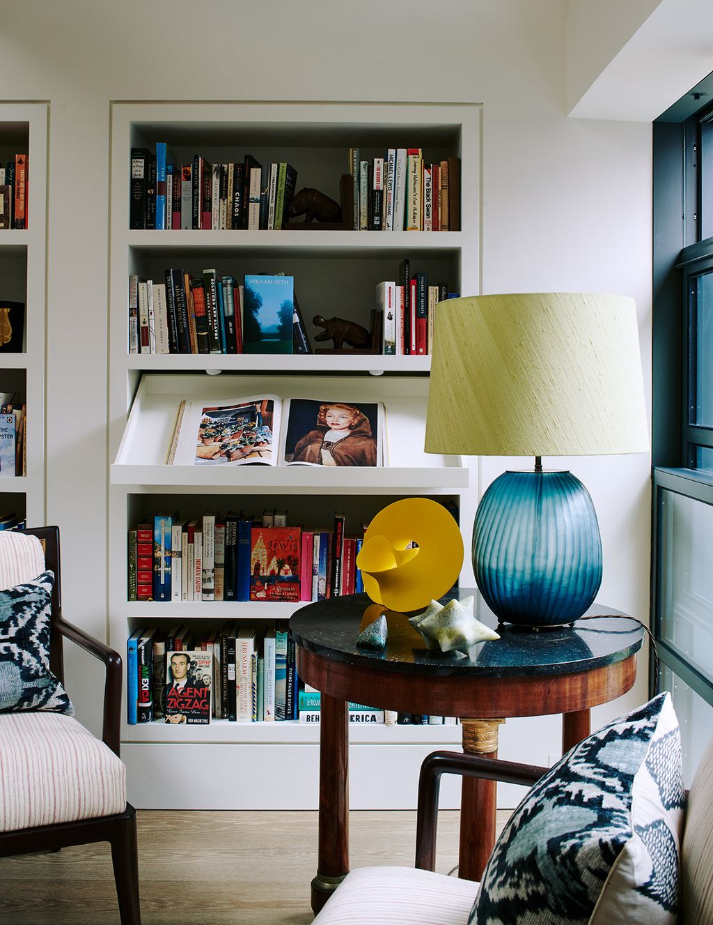 Image may contain Furniture Book Shelf Bookcase Living Room Room Indoors and Marlene Dietrich