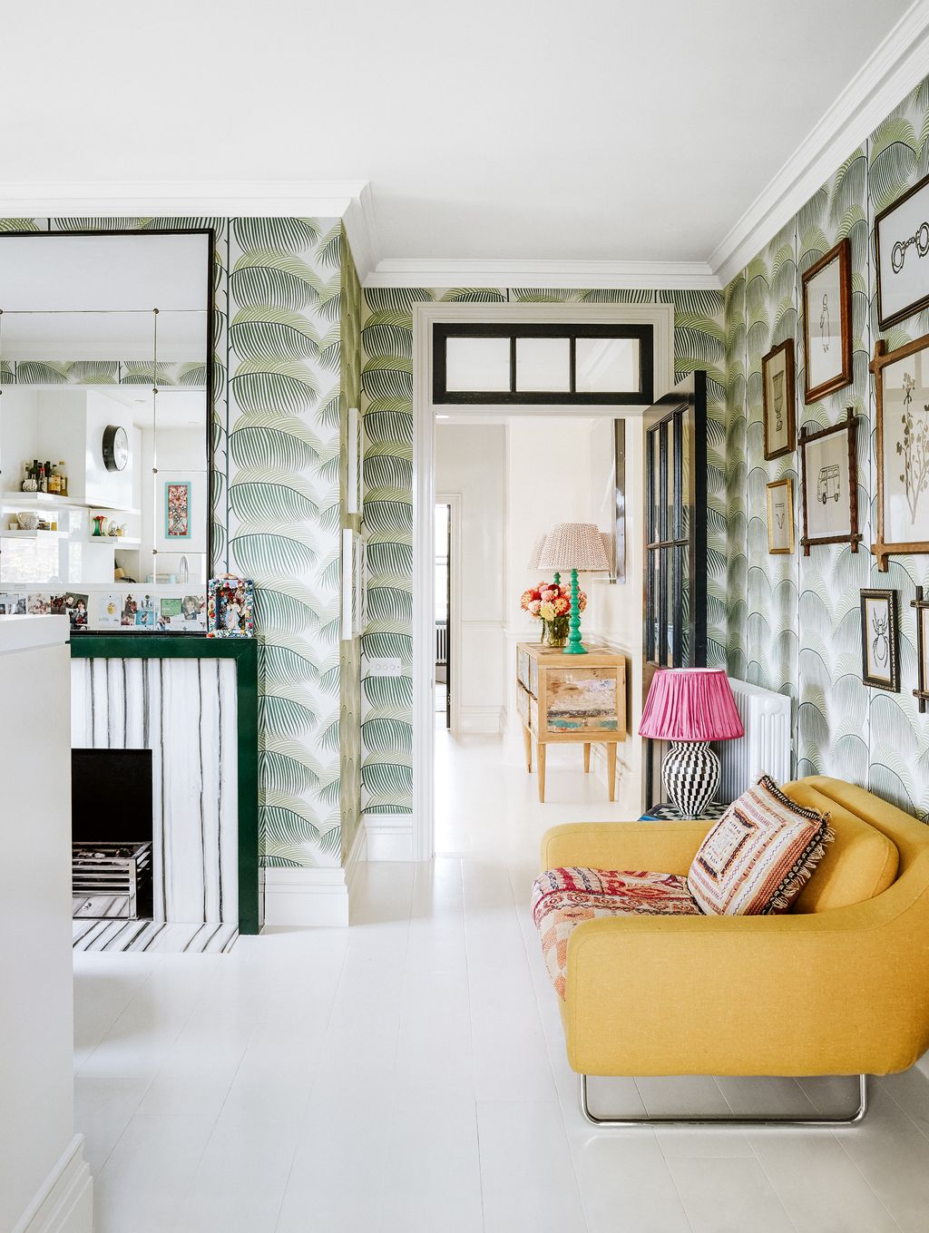 In the airy sitting room of a photographer's Chelsea maisonette Sanderson's 'Manila' wallpaper makes for a cheerful...
