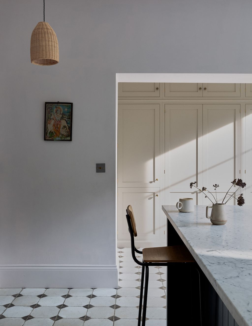 The kitchen opens through to a pantry where the washing machine and dryer are concealed along with other small...