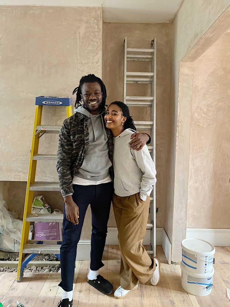 Image may contain: Human, Person, Clothing, Apparel, Footwear, Shoe, Pants, Wood, and Shelf