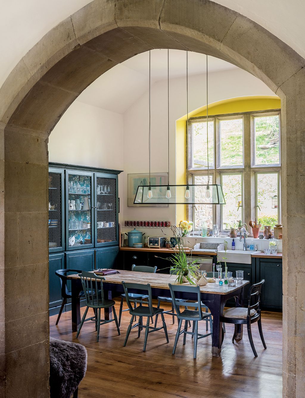 In what was the smaller classroom a ‘Diner Pendant light from Holloways of Ludlow hangs above an old wooden table bought...