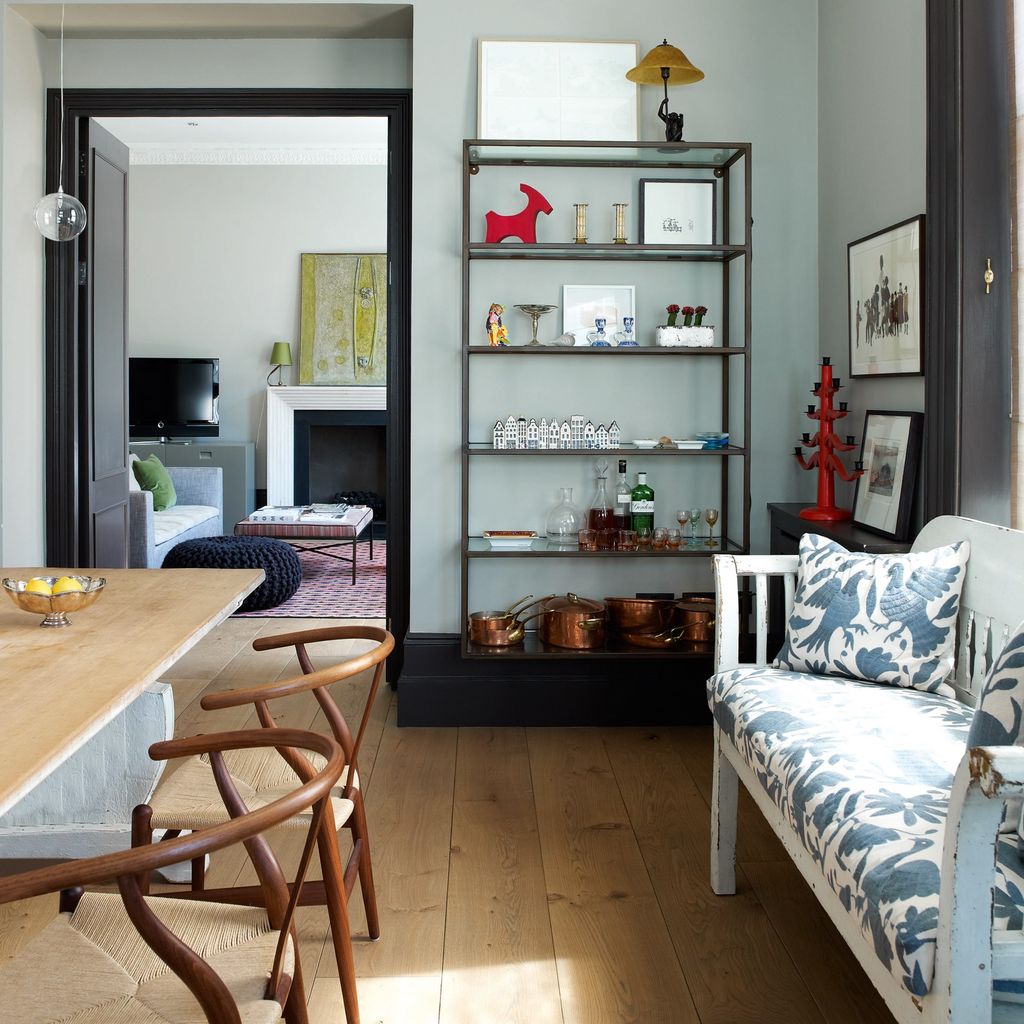 Image may contain Indoors Interior Design Living Room Room Flooring Wood Hardwood Furniture Floor Shelf and Couch