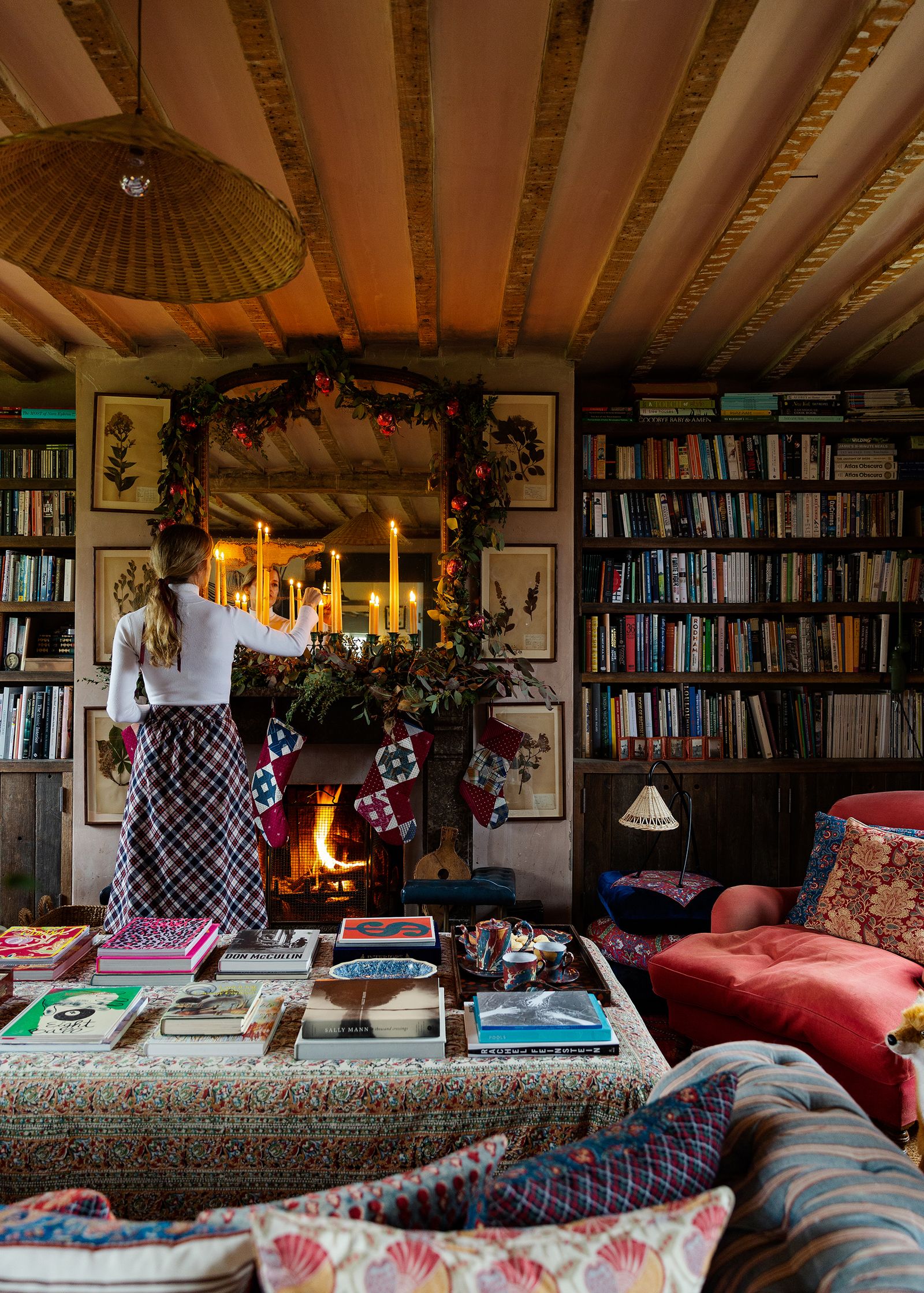 Image may contain Furniture Living Room Room Indoors Interior Design Human Person Bookcase Shelf and Couch