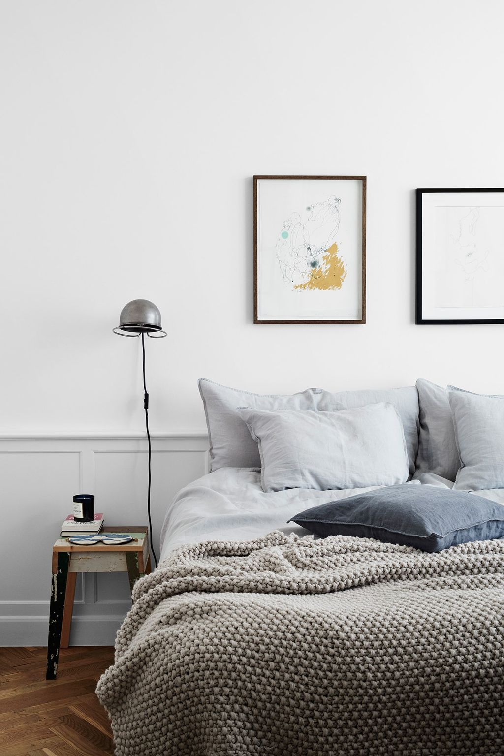 Simple framed pictures hang above the bed in the white bedroom. Similar Bed Linen here 79.99 similar blanket 49.99 here...