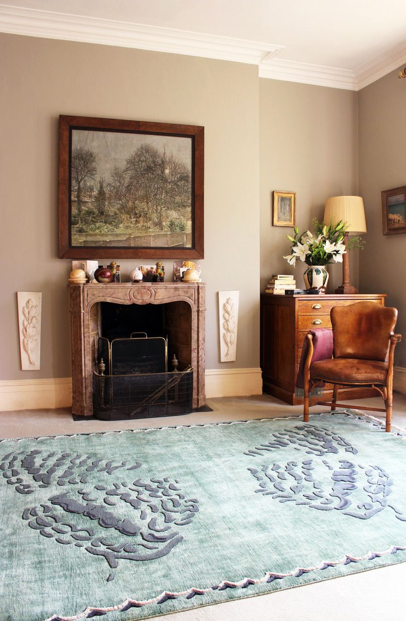 Image may contain Rug Furniture Indoors Home Decor Room Fireplace Living Room and Interior Design