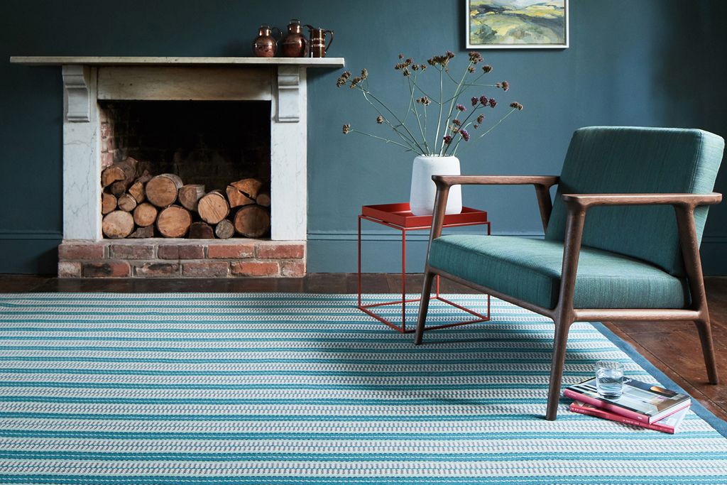 Image may contain Furniture Chair Rug Indoors and Fireplace