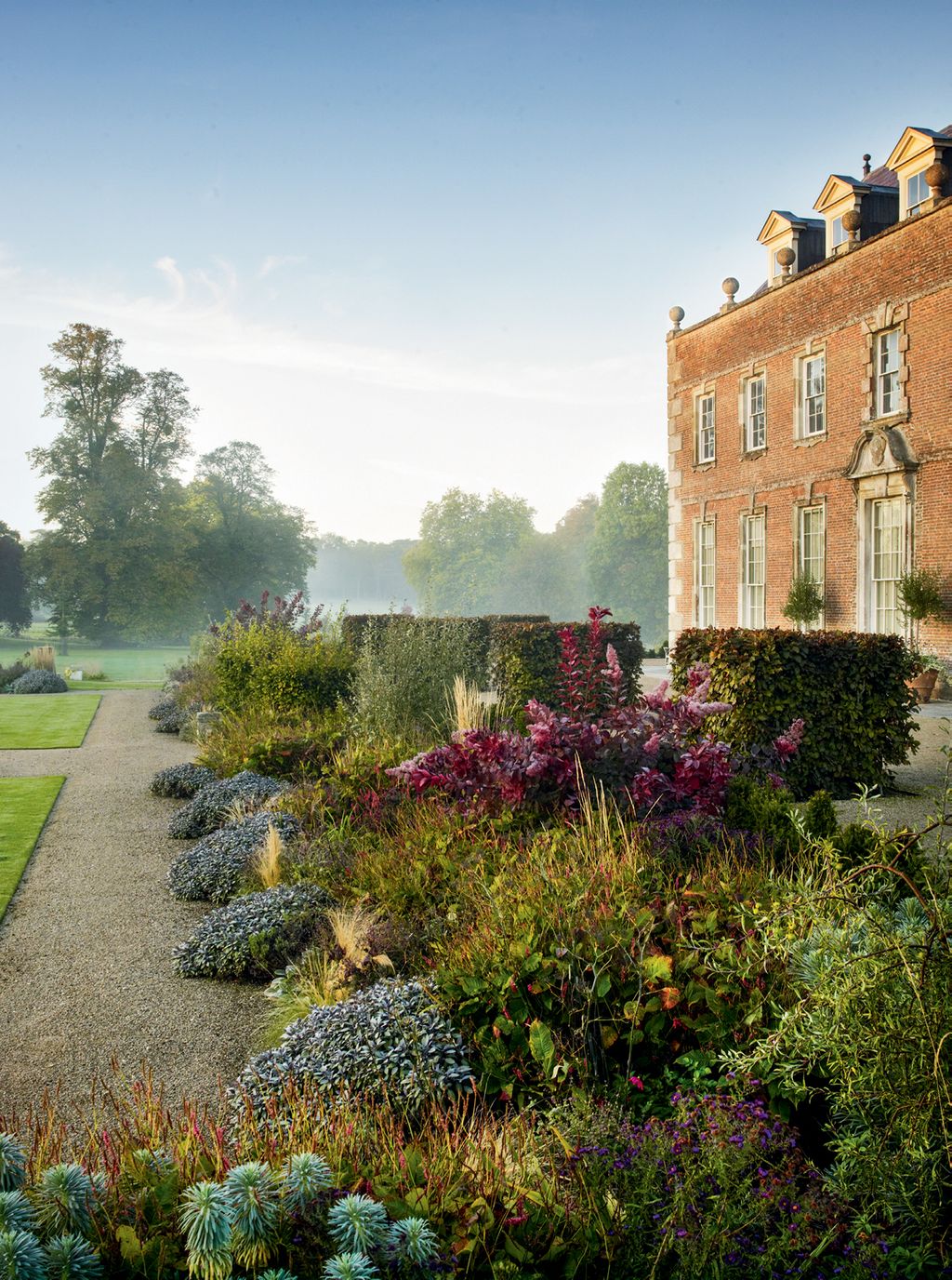 Image may contain Grass Plant Gravel Road Dirt Road Building Human Person and Housing