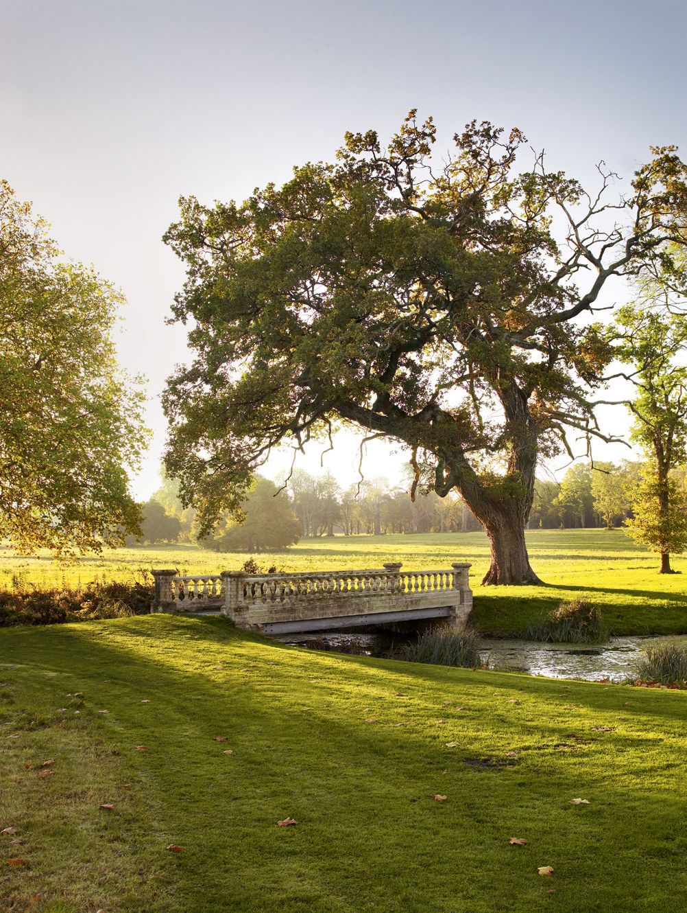 A stone bridge spans the canal that feeds into the lake.