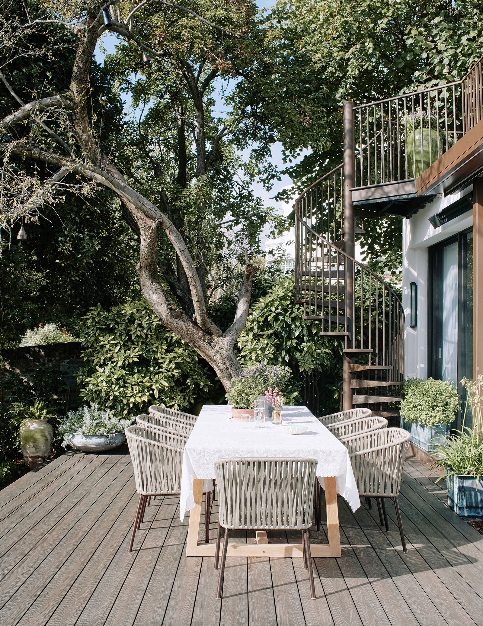 Image may contain Furniture Chair Table Dining Table Patio Porch and Tablecloth