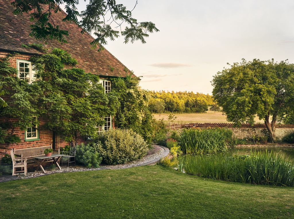 Image may contain Grass Plant Furniture Bench Outdoors Nature Building Countryside Shelter Rural Lawn and Housing