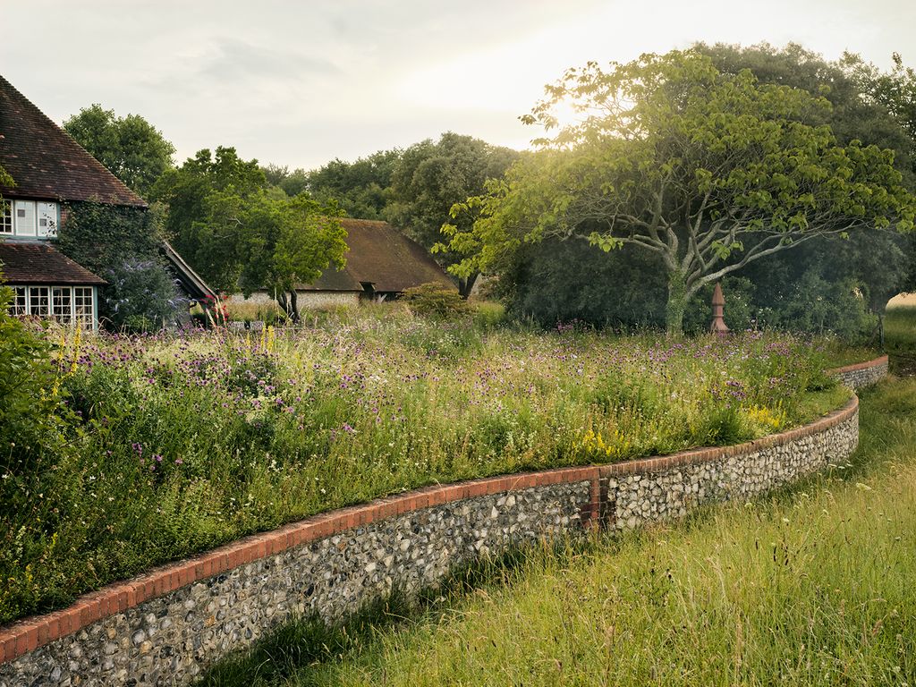 Image may contain Nature Outdoors Countryside Plant Rural Grassland Field Building Grass Spire and Architecture