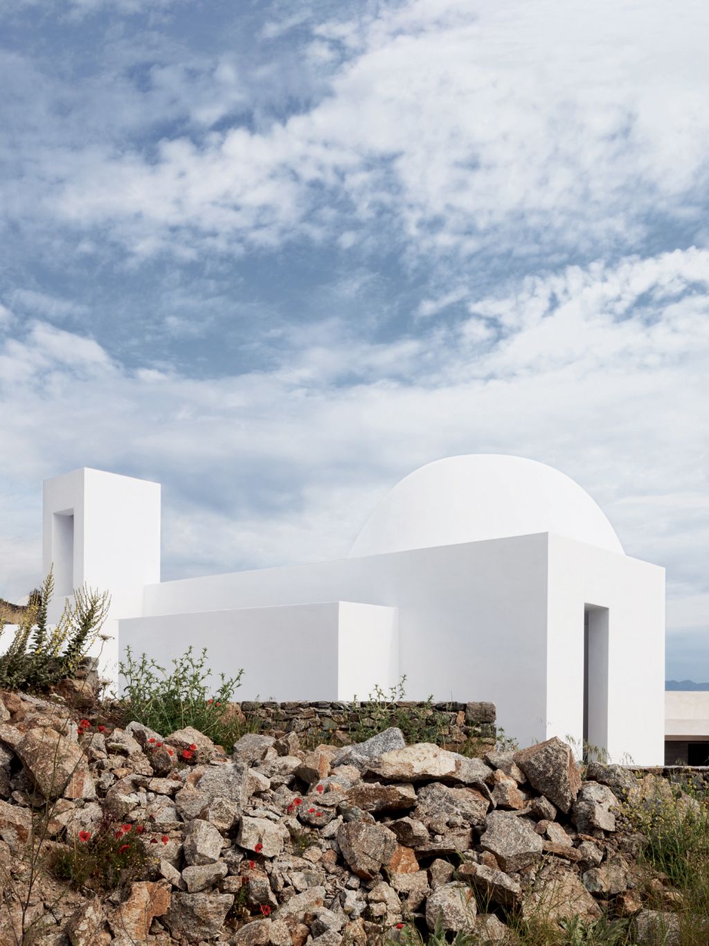 The chapels white walls contrast with the rocky landscape in this view of the tall aperture on the western side of the...