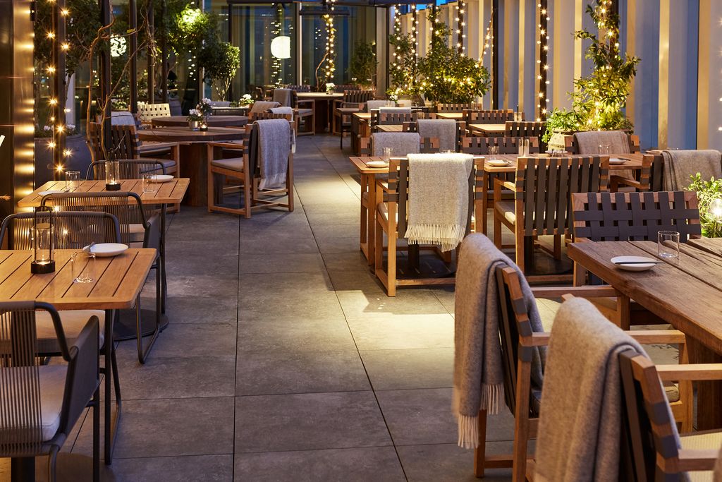 Image may contain Furniture Chair Restaurant Cafe Wood Cafeteria City Town Urban Building and Metropolis