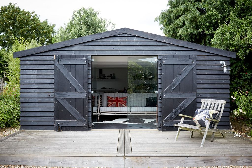 Formerly an unused outbuilding now Sarah's stylish studio looks like a barn when closed.