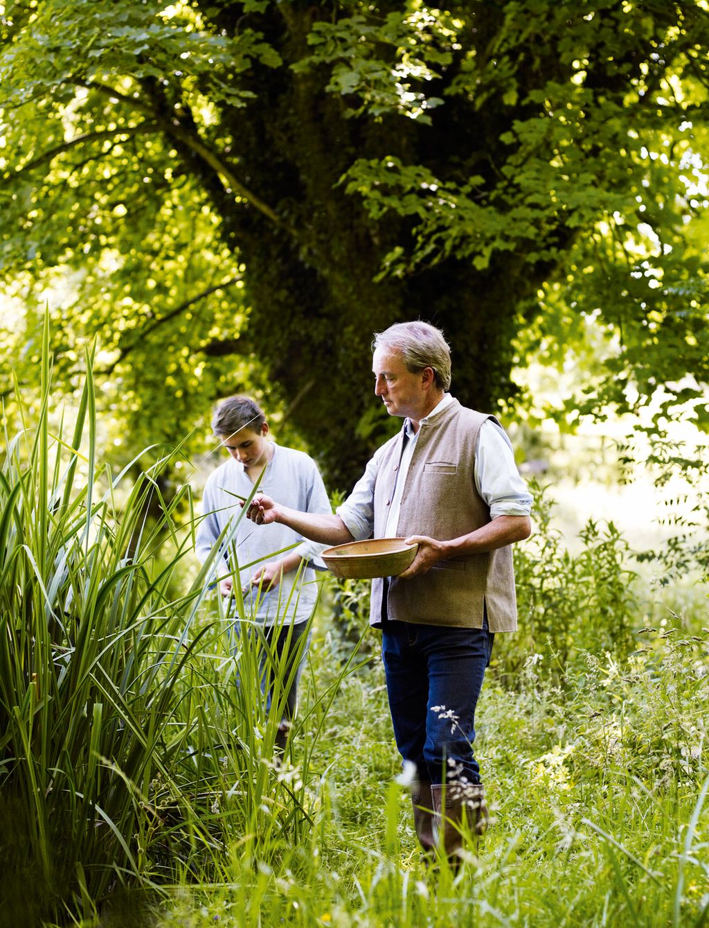 Philip and his son Oliver examine plants in the garden at Duck End.