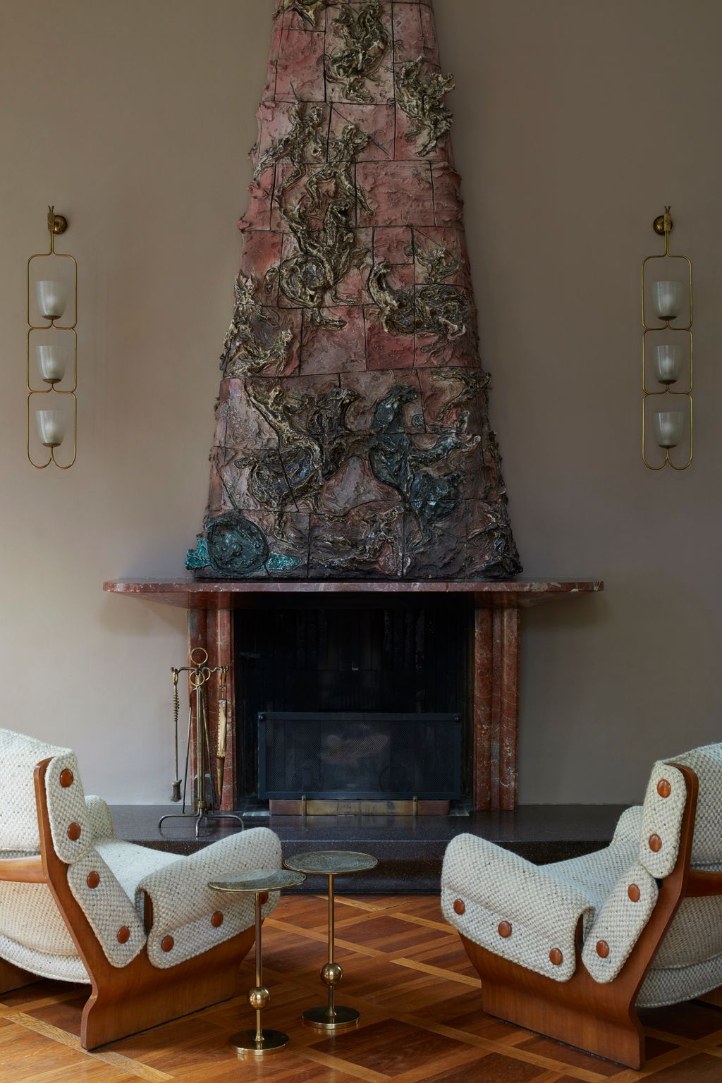 A sculptural fireplace by Lucio Fontana anchors the living room at Villa Borsani north of Milan. Flanking it are a pair...