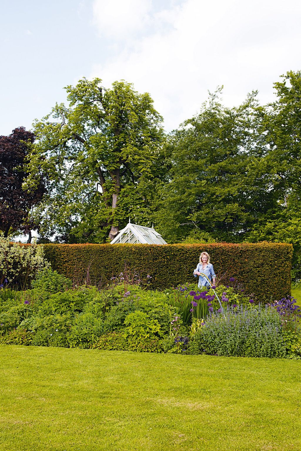 Anna waters the garden.