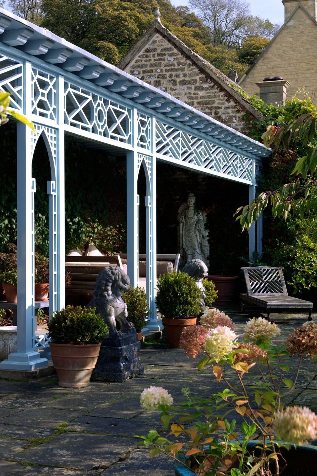 Image may contain Patio Porch Human Person Outdoors Furniture Bench Flagstone Garden and Arbour