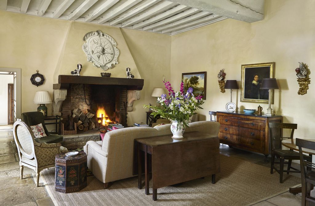 Image may contain Living Room Indoors Room Flooring Interior Design Furniture Chair Wood Plant Hardwood and Couch