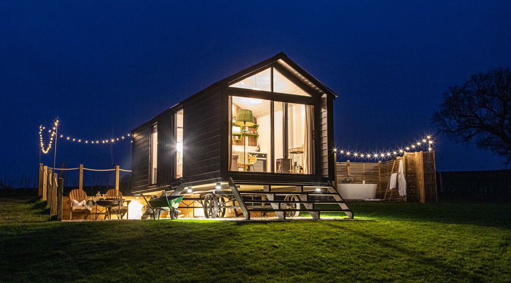 Image may contain Grass Plant Furniture Bench Lawn Building Outdoors Housing and Nature