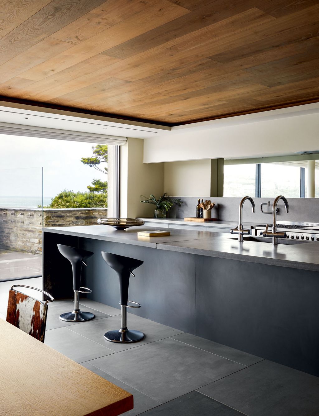 Units designed by architects McLean Quinlan and made by a local joiner have been teamed with polished concrete worktops....