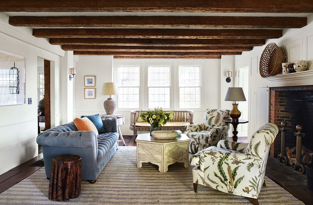 Image may contain Living Room Room Indoors Furniture Couch Rug Table Wood Coffee Table Cushion and Pillow