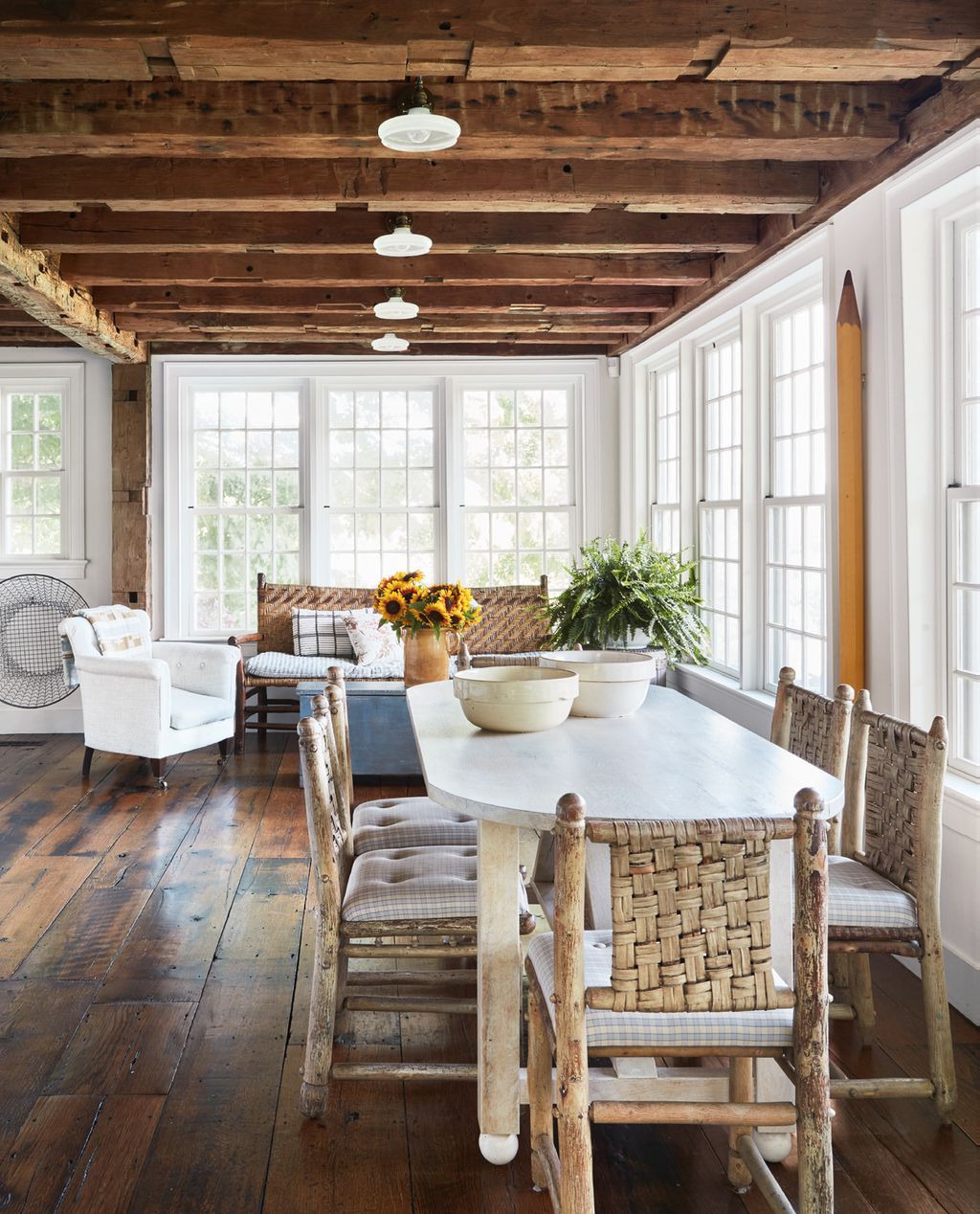 A primitivestyle dining table is teamed with vintage hickory chairs the cushions are in Lee Jofas ‘Courtenay cotton in...